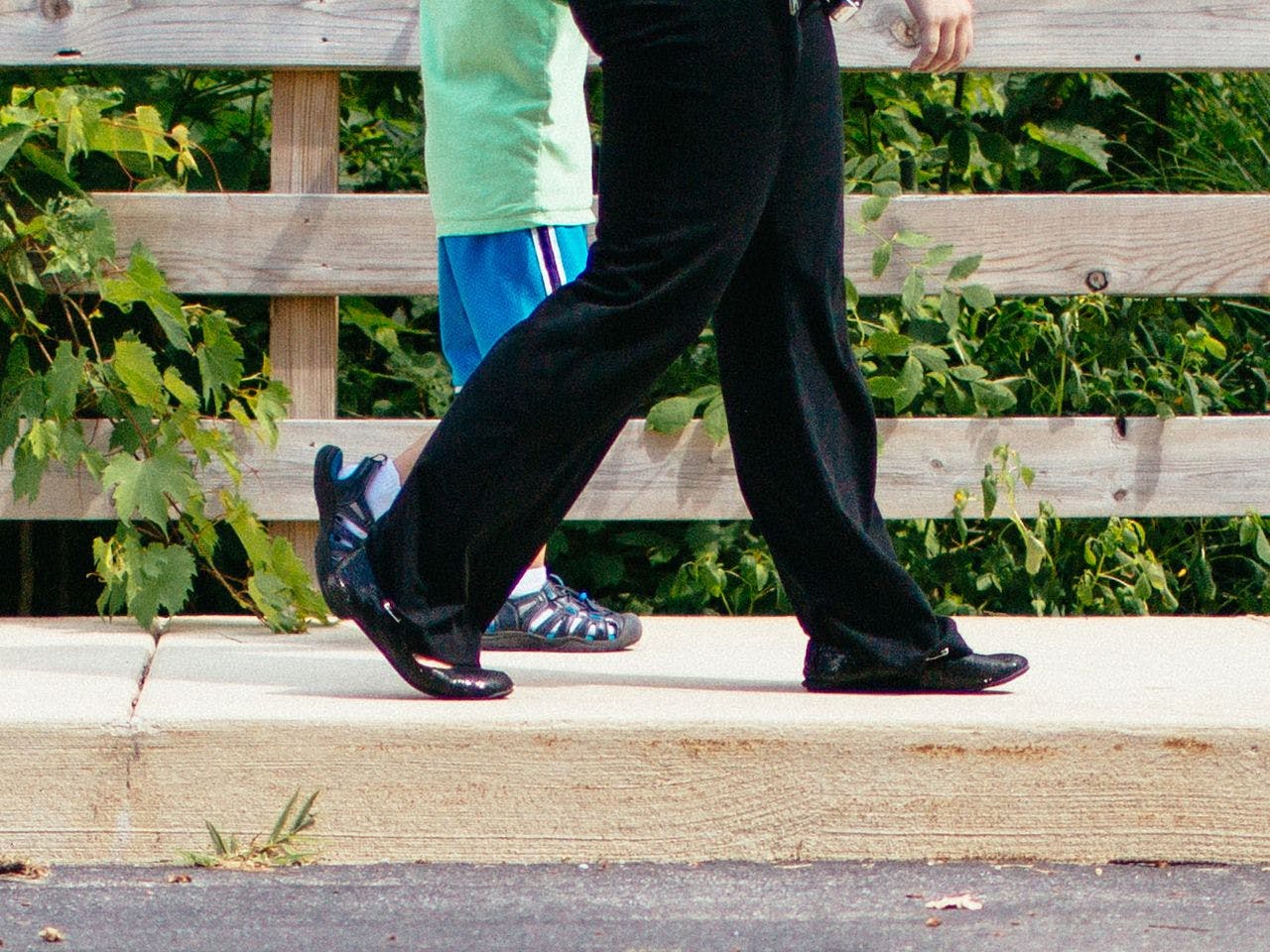 child and adult walking